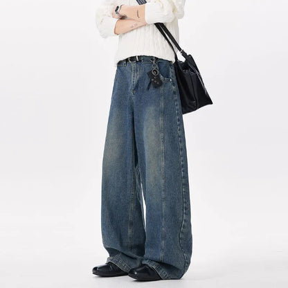 Person wearing wide-leg jeans and a white sweater on a white background