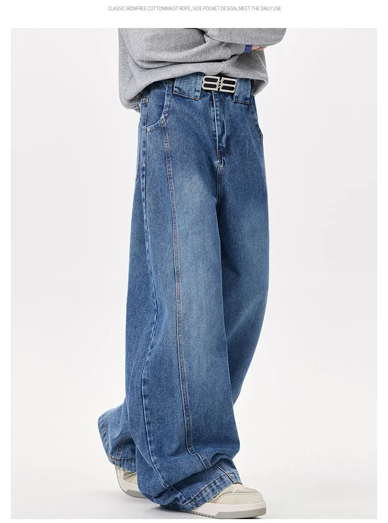 Person wearing blue jeans and a gray sweater on a white background