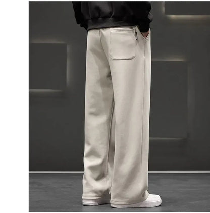 Person wearing beige pants and white shoes in a minimalistic setting