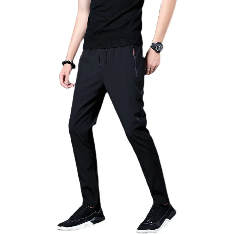Person wearing black pants on a white background