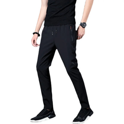 Person wearing black pants on a white background