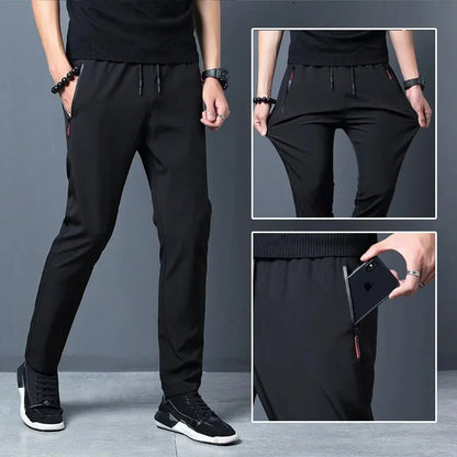 Person wearing black pants with a close-up inset showing details on a gray background