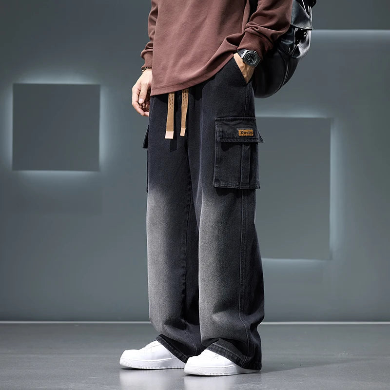 Person wearing dark gray cargo pants with a plain background
