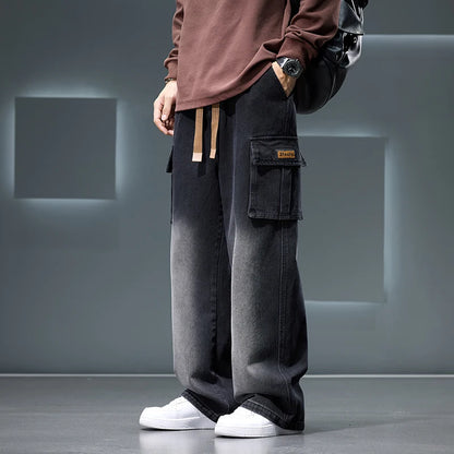 Person wearing dark gray cargo pants with a plain background