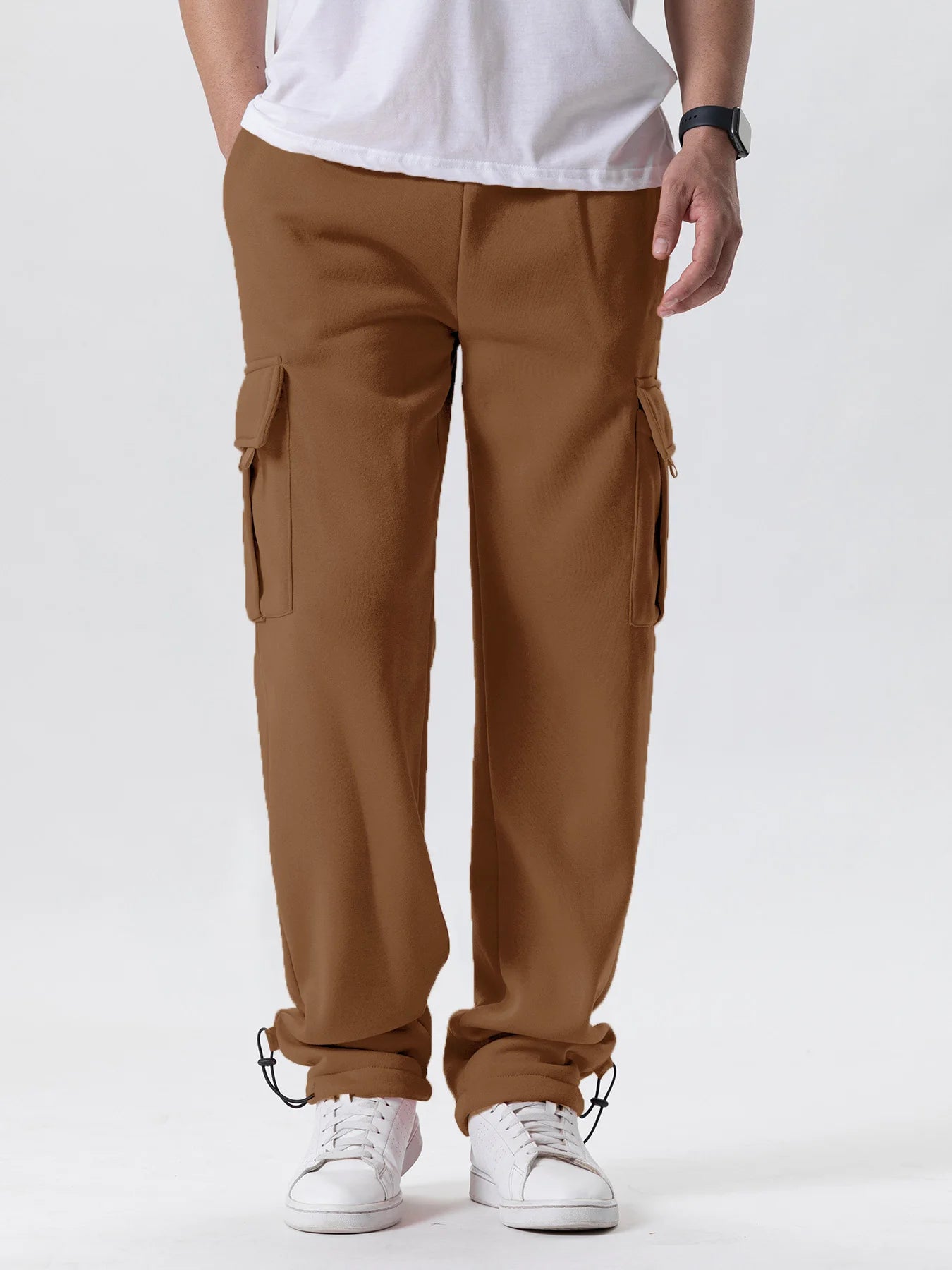 Person wearing brown cargo pants on a white background