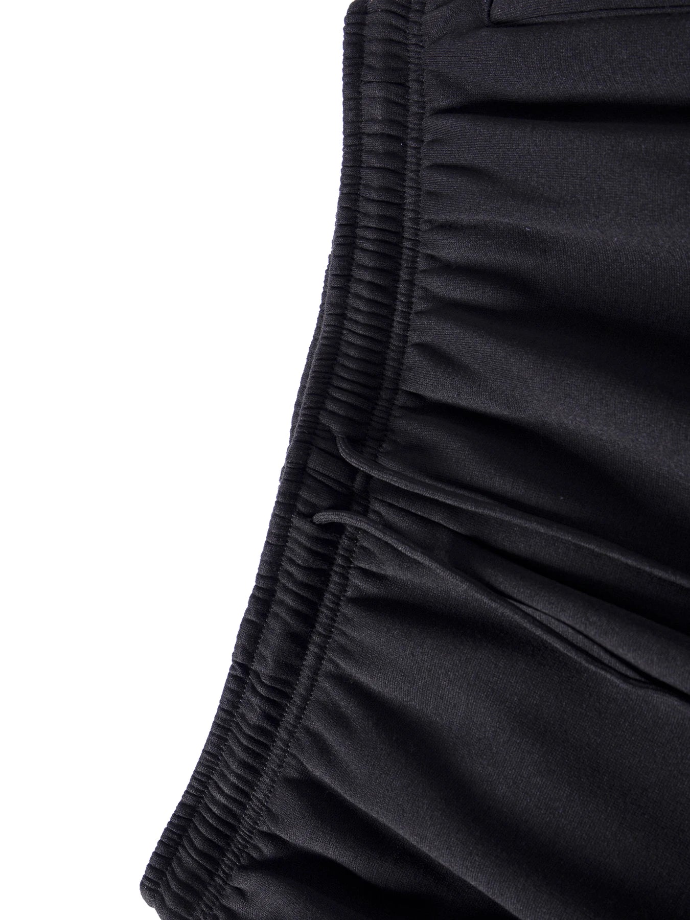Close-up of black shorts with a white background