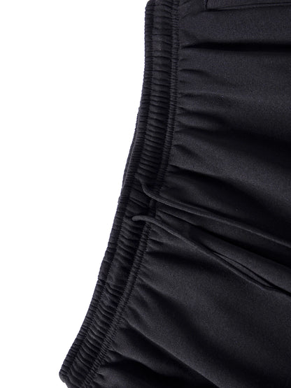 Close-up of black shorts with a white background