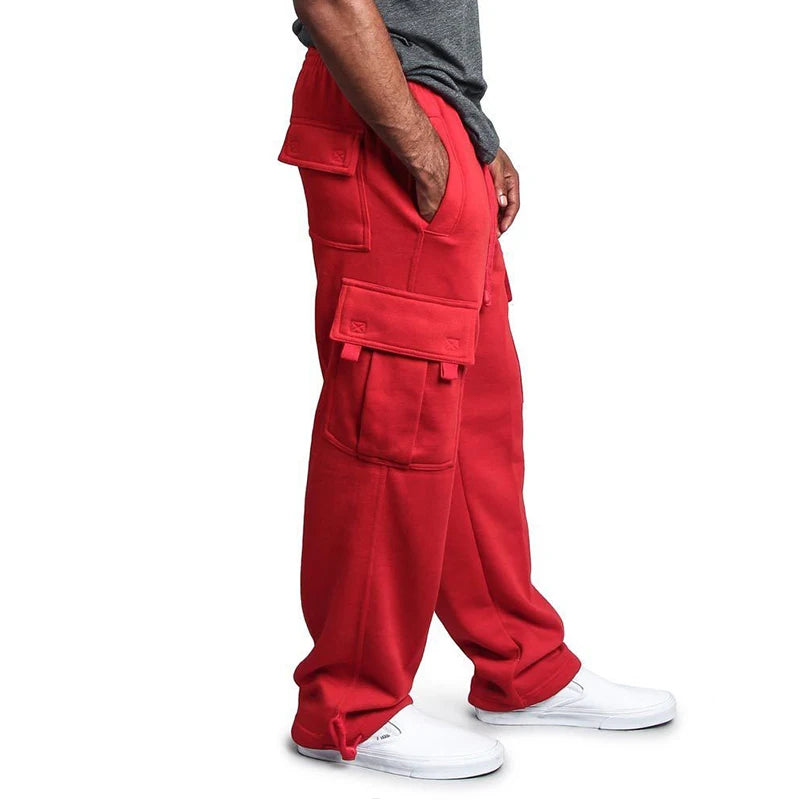 Red cargo pants worn by a person on a white background